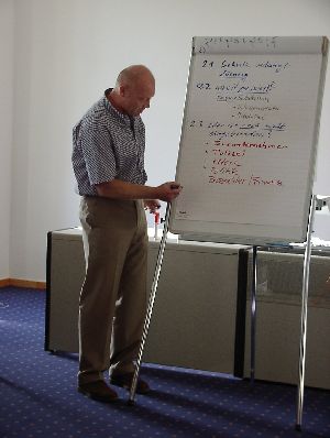 Jetzt schreibt er schon fleißig auf der Flipchart – nach den Angaben der Kollegen